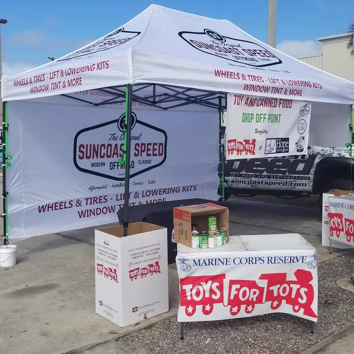 A vibrant red custom printed canopy tent at an outdoor market.