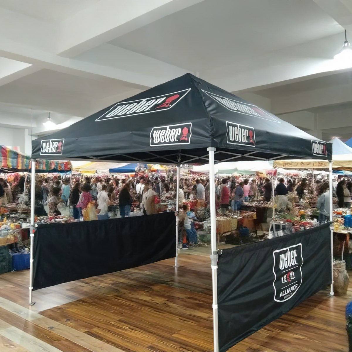 A branded canopy tent used for a professional business promotion outdoors.